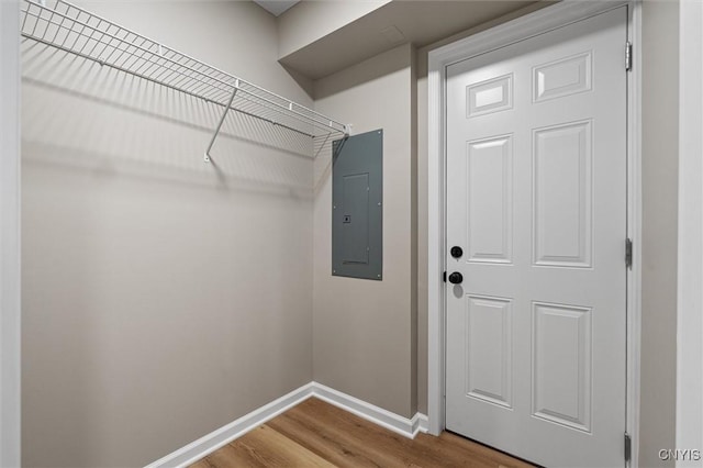 614 E Broadway St, Fulton, NY 13069 - clothes washing area with electric panel, wood finished floors, and baseboards