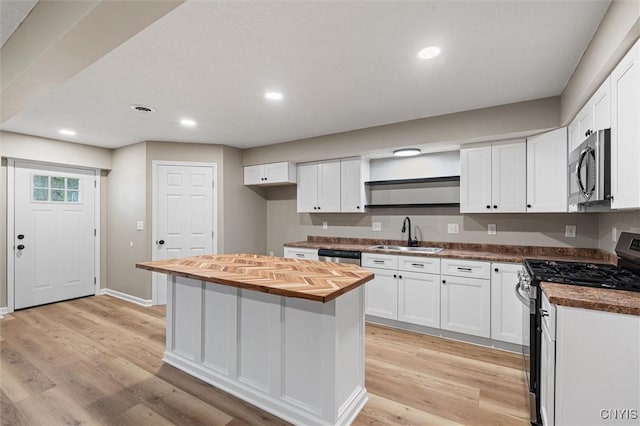 614 E Broadway St, Fulton, NY 13069 - kitchen with stainless steel appliances, butcher block counters, a sink, white cabinetry, and recessed lighting