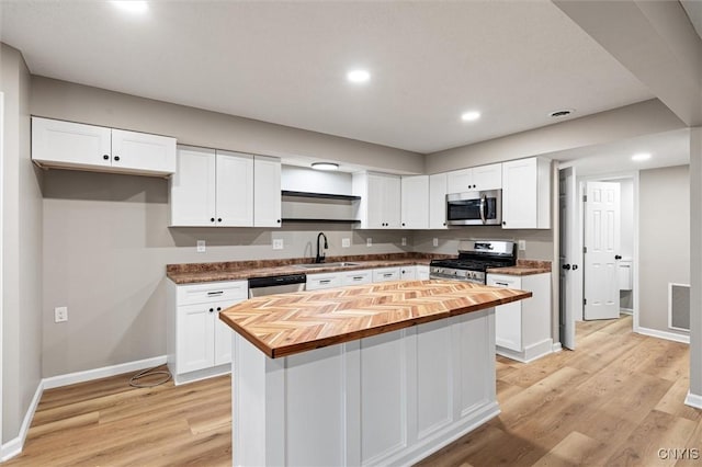614 E Broadway St, Fulton, NY 13069 - kitchen with butcher block counters, stainless steel appliances, a sink, white cabinetry, and recessed lighting