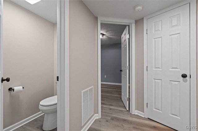 614 E Broadway St, Fulton, NY 13069 - bathroom with toilet, wood finished floors, and baseboards