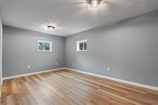 614 E Broadway St, Fulton, NY 13069 - unfurnished room featuring a textured ceiling, baseboards, and light wood-style floors