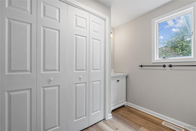 614 E Broadway St, Fulton, NY 13069 - bathroom with a closet, wood finished floors, baseboards, and vanity