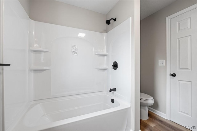 614 E Broadway St, Fulton, NY 13069 - bathroom with toilet, wood finished floors, baseboards, and  shower combination