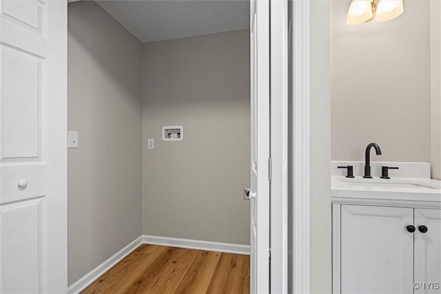 614 E Broadway St, Fulton, NY 13069 - washroom featuring washer hookup, light wood finished floors, and baseboards