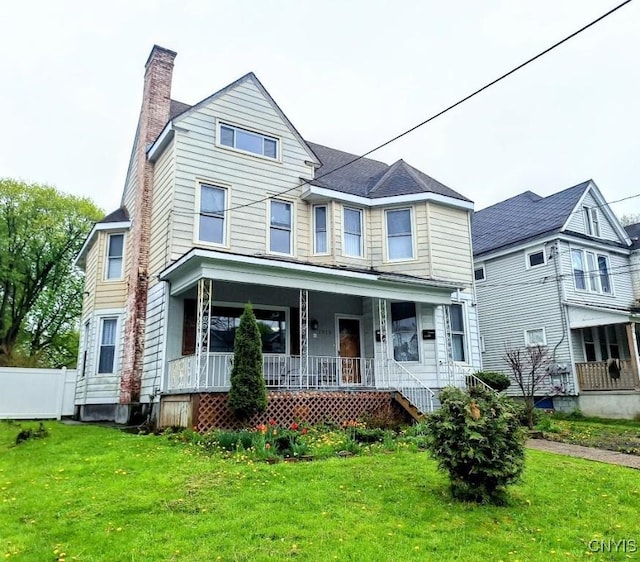 view of front of house featuring a porch and a chimney