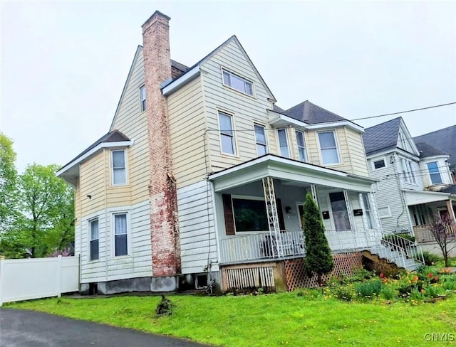 view of front of home with a porch and a chimney