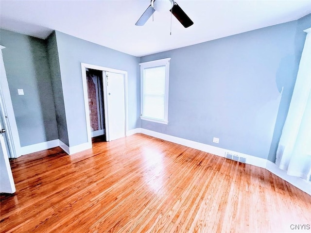 unfurnished bedroom with light wood-style floors, baseboards, a closet, and a ceiling fan
