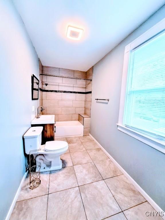 bathroom featuring toilet, tile patterned flooring, and baseboards