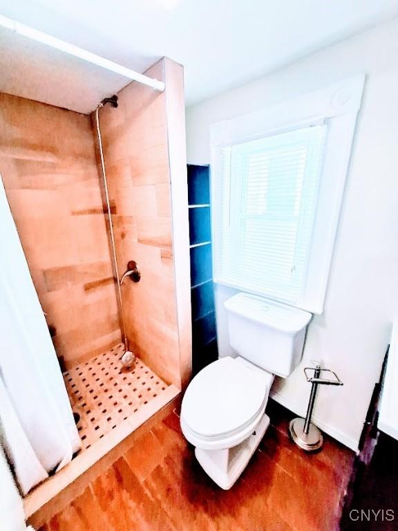 full bathroom with a shower stall and toilet