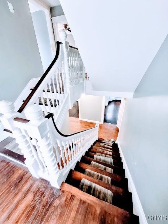 stairway with wood finished floors