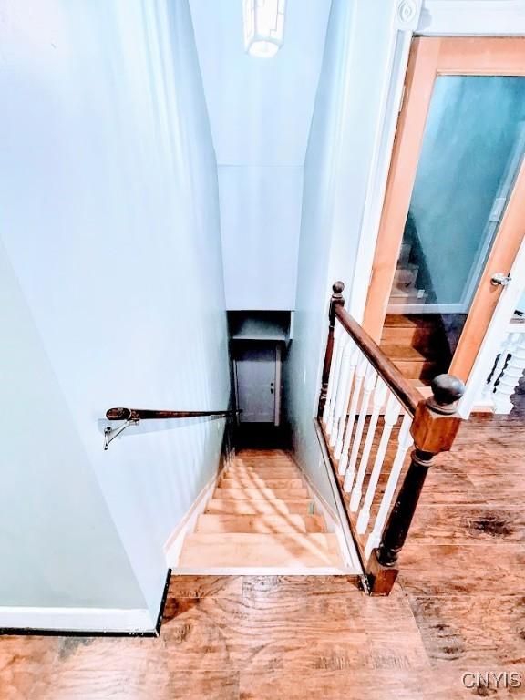 staircase with wood finished floors