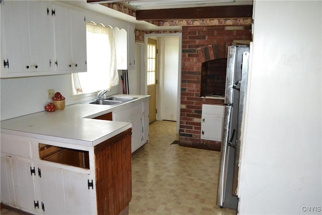 206 Marilyn Ave, Salina, NY 13212 - kitchen with a sink, light floors, freestanding refrigerator, light countertops, and white cabinets