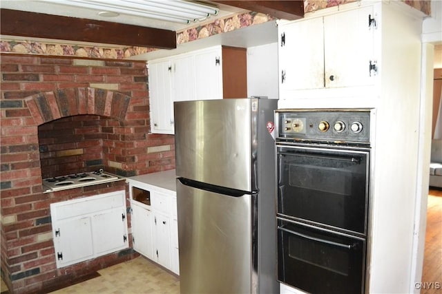 206 Marilyn Ave, Salina, NY 13212 - kitchen with freestanding refrigerator, white stovetop, white cabinets, beam ceiling, and light floors