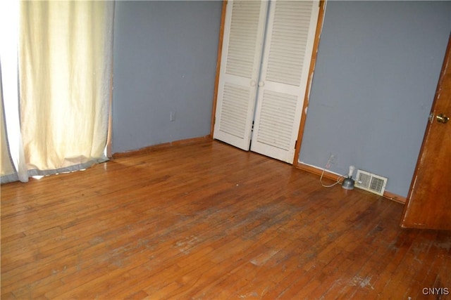 206 Marilyn Ave, Salina, NY 13212 - unfurnished bedroom with wood-type flooring, a closet, and baseboards