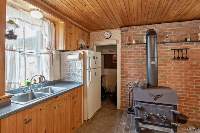 3542 Griffin Rd, Onondaga, NY 13215 - kitchen with a sink, a wood stove, wooden ceiling, dark tile patterned floors, and dark countertops