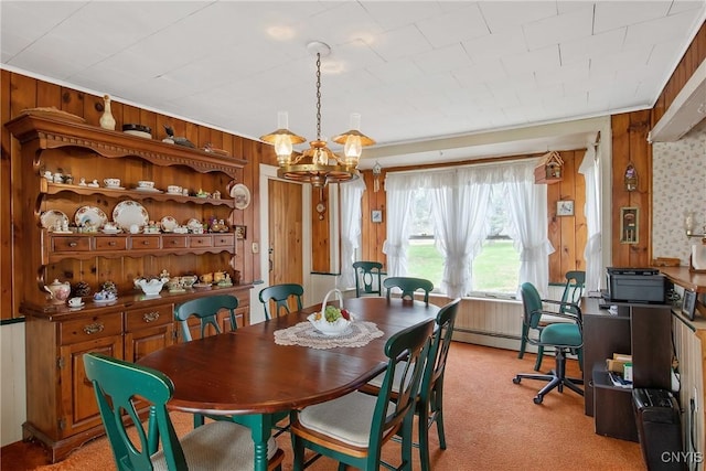 3542 Griffin Rd, Onondaga, NY 13215 - dining space featuring a chandelier, wood walls, light colored carpet, and a baseboard heating unit