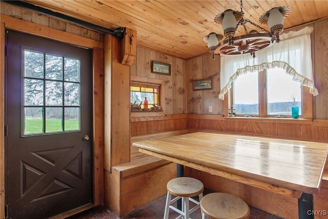 3542 Griffin Rd, Onondaga, NY 13215 - dining area featuring wood ceiling, wooden walls, and a chandelier