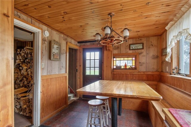 3542 Griffin Rd, Onondaga, NY 13215 - dining space with wooden walls, a chandelier, and wood ceiling