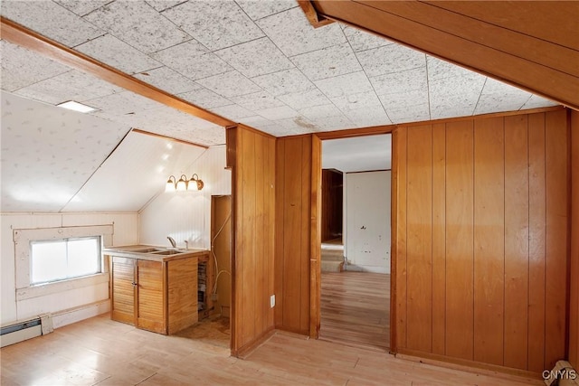 3542 Griffin Rd, Onondaga, NY 13215 - additional living space with light wood-type flooring, wood walls, a baseboard heating unit, and vaulted ceiling
