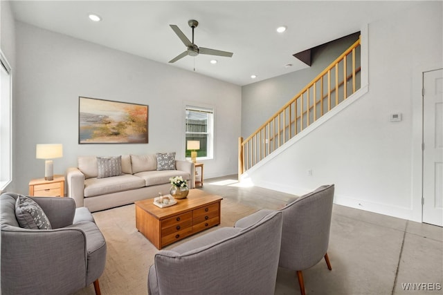 living area featuring stairway, ceiling fan, recessed lighting, baseboards, and finished concrete floors