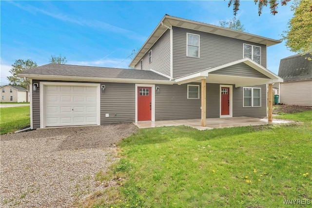 traditional-style home featuring an attached garage, a front lawn, and gravel driveway