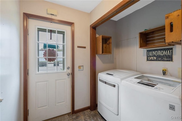 laundry area with washer and dryer, baseboards, and cabinet space