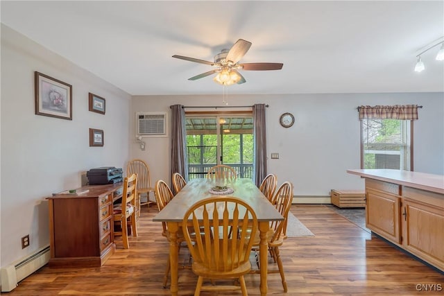 dining room with a baseboard heating unit, ceiling fan, and plenty of natural light