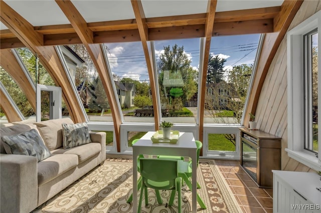 sunroom / solarium with plenty of natural light and tile patterned floors