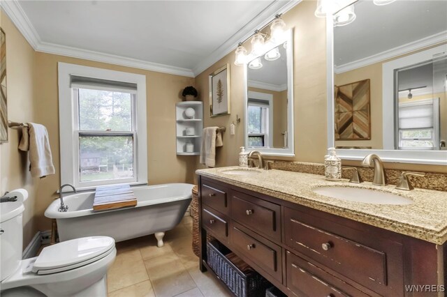 bathroom featuring toilet, healthy amount of natural light, a freestanding tub, ornamental molding, and tile patterned flooring