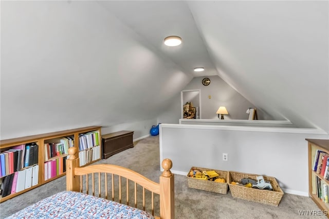 carpeted bedroom with vaulted ceiling and baseboards