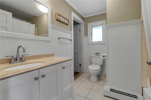 bathroom with toilet, vanity, a wainscoted wall, crown molding, and tile patterned floors