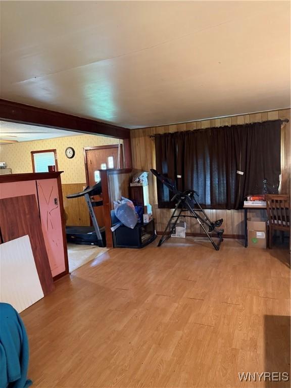 6358 Dale Rd, Newfane, NY 14108 - workout room with wood finished floors, wooden walls, and wallpapered walls