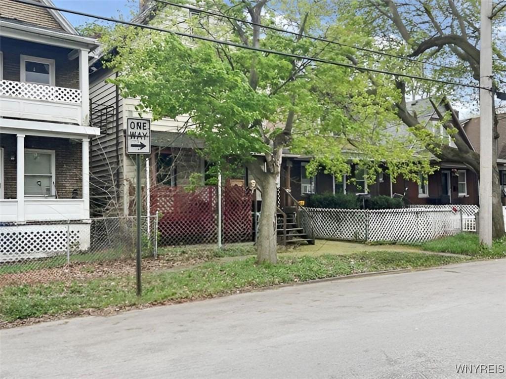 view of home's exterior featuring fence and brick siding