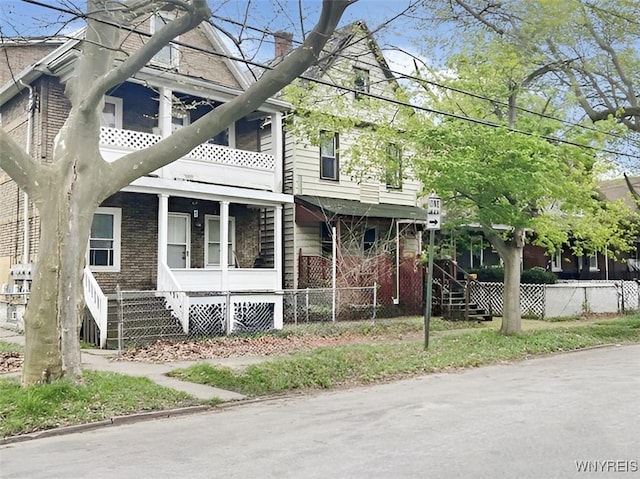 view of side of home featuring a chimney, fence, and stairs