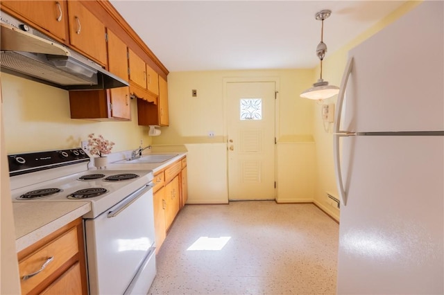 kitchen with white appliances, under cabinet range hood, a sink, light countertops, and decorative light fixtures