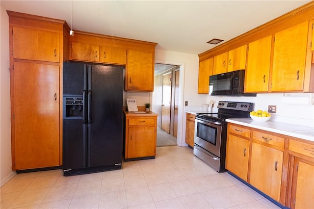kitchen with black appliances, light countertops, and brown cabinetry