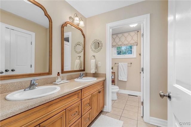 4314 Arbutus Dr, Pompey, NY 13104 - full bath with toilet, tile patterned flooring, double vanity, and baseboards