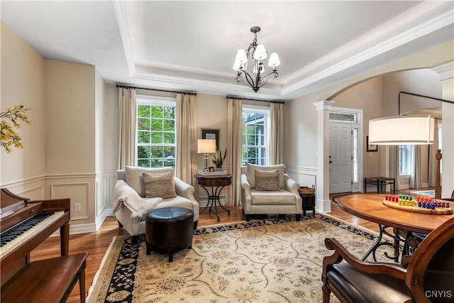 4314 Arbutus Dr, Pompey, NY 13104 - sitting room with arched walkways, wood finished floors, ornate columns, a tray ceiling, and wainscoting
