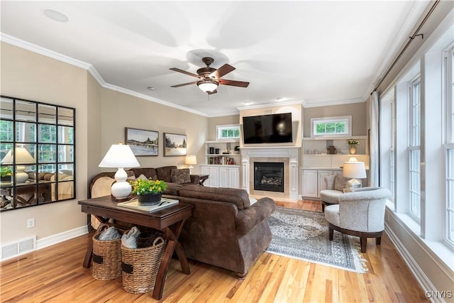4314 Arbutus Dr, Pompey, NY 13104 - living area featuring ceiling fan, wood finished floors, a glass covered fireplace, baseboards, and ornamental molding