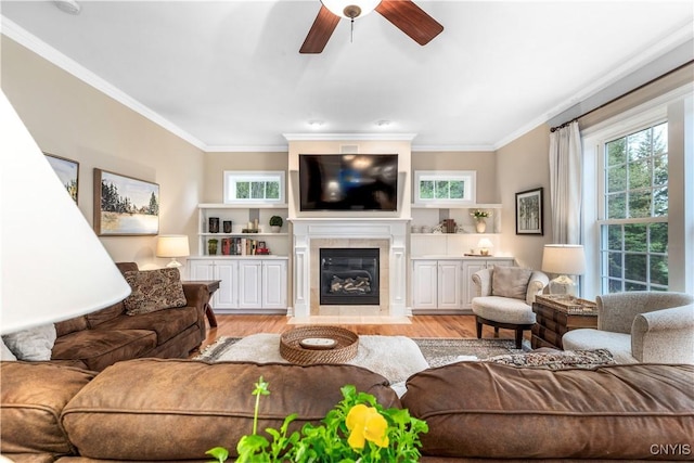 4314 Arbutus Dr, Pompey, NY 13104 - living room with ceiling fan, crown molding, light wood-style flooring, and a tile fireplace