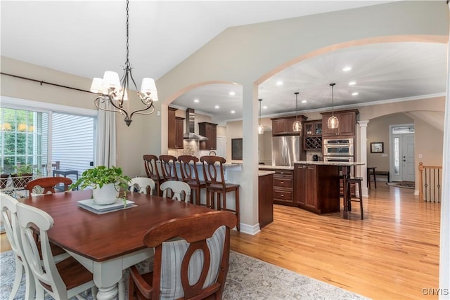 4314 Arbutus Dr, Pompey, NY 13104 - dining room featuring arched walkways, light wood finished floors, recessed lighting, a chandelier, and vaulted ceiling