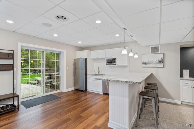 4314 Arbutus Dr, Pompey, NY 13104 - kitchen with stainless steel appliances, baseboards, white cabinets, a peninsula, and a drop ceiling