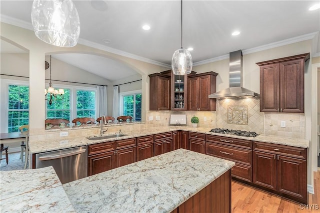 4314 Arbutus Dr, Pompey, NY 13104 - kitchen featuring appliances with stainless steel finishes, wall chimney exhaust hood, a sink, arched walkways, and light wood-style flooring
