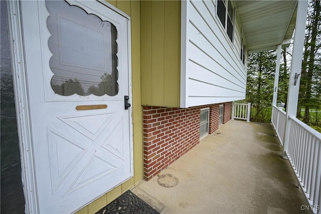 property entrance featuring brick siding