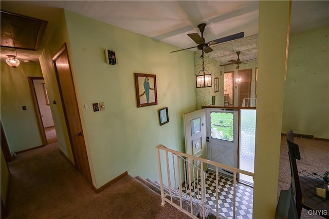 staircase with attic access, carpet flooring, ceiling fan, and baseboards