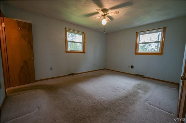 unfurnished room with ceiling fan, carpet flooring, and baseboards