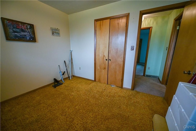 unfurnished bedroom featuring carpet, a closet, and baseboards