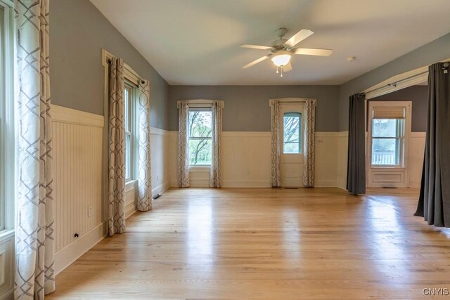 1957 Torpy Pond Rd, Georgetown, NY 13061 - empty room featuring wainscoting, light wood-style floors, and ceiling fan