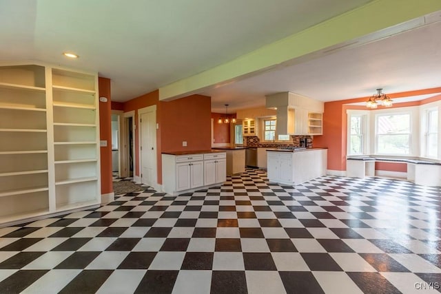 1957 Torpy Pond Rd, Georgetown, NY 13061 - kitchen featuring a chandelier, dark countertops, stainless steel dishwasher, white cabinets, and recessed lighting