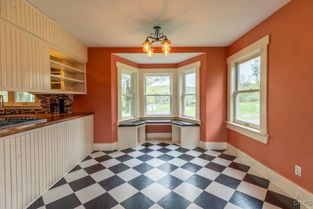 1957 Torpy Pond Rd, Georgetown, NY 13061 - dining area with dark flooring, baseboards, and a chandelier